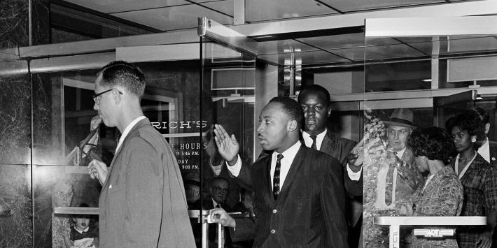 Civil rights leader Dr. Martin Luther King Jr. exits Rich's department store in Atlanta, Ga., Oct. 19, 1960.