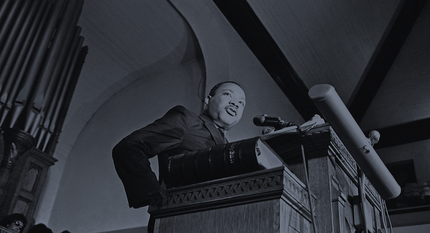 Dr. Martin Luther King Jr., tells a mass meeting in Birmingham, Alabama Sept. 17, 1963 that words and actions of Alabama Gov. George Wallace were to blame for the deaths of four African American girls in a church bombing. The meeting of about 1,200 persons voted to state a march on the state capitol in Montgomery to protest racial violence. (AP Photo)